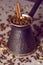 Vintage filtered turkish coffee pot filled with coffee beans on canvas background