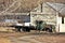 Vintage flatbed ranch truck parked in front of a barn