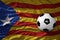 Vintage football ball on the waveing national flag of catalonia background. 3D illustration
