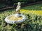 A vintage fountain in the green park which creates aesthetic atmosphere