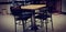 Vintage four black chairs around wood and steel table in cafe