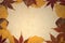 Vintage frame with autumnal leaves on ancient sepia paper. Copy space.