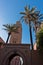 Vintage gate with palm trees in front of Koutoubia mosque at sunset, Marrakech, Morocco