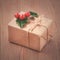 Vintage gift box, kraft paper, rope and holly berries on old wooden