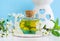 Vintage glass bottle with cosmetic oil massage oil, tincture, infusion, extract and white flowers close up. Aromatherapy, spa