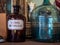 Vintage glass bottle on wooden shelf. Empty danger chemical bottle
