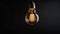 A vintage glowing light bulb hangs against a dark background, emitting a warm, soft glow