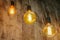 Vintage glowing light bulbs. Three hanging retro incandescent lamps