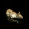 Vintage gold figurine of a cat on a black isolated background