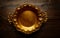 Vintage golden tray round on aged brown wood