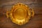 Vintage golden tray round on aged brown wood