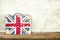 Vintage Great Britain flag suitcase put on wooden board with old