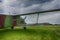 Vintage green biplane parked in a lush green field