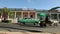 Vintage Green Car Parked In Front Of Colorful Cuban Buildings