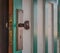 Vintage green and white striped open door with 1940`s era hardware