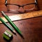 Vintage green writing utensils, ruler and spectacles.