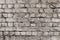 Vintage grey brick wall texture. White old cement wall background. Pattern with gray dilapidated bricks. Blank concrete grunge wal