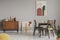 Vintage grey dining room with abstract paintings