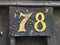 Vintage grunge square wooden plate of number of street address with number