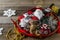 Vintage handmade Christmas toys and decor on a tray on wooden rustic background