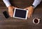 Vintage hipster wooden desktop top view, male hands using laptop