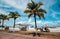 Vintage horse drawn carriages parked along the street and seawall on Cozumel island