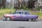 Vintage hotrod driving on country road