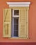 Vintage house pale yellow shutters window
