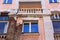 Vintage house with a sprinkle plaster. Old building and new Windows. Small columns.