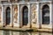 Vintage house, Venice, Italy. Ornate facade of old building with doors and statues