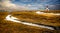 Vintage Icelandic church stands in middle of meadow of high grasses in Winter