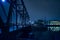 Vintage industrial railroad bridge at night