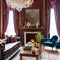 A vintage-inspired sitting room with velvet armchairs, an ornate fireplace, and a collection of antique decor pieces4, Generativ
