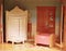 Vintage interior of baby dollhouse. Cute tiny doll room with closet and cradle.