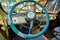 Vintage interior of an old car with a retro dashboard and steering wheel in a PVC cover