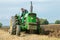 Vintage John Deere tractor pulling a plough