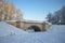 Vintage Karpin bridge of the Gatchina park on a january day. Russia