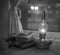 Vintage kerosene lamp with fire on a blurred background of the window and curtains with a book and glasses