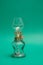 Vintage kerosene lamp on green background