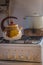Vintage kettle and soup pan on gas stove. Retro kitchenware in village. Rustic household equipment.