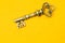 Vintage key isolated on yellow background