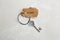 Vintage key with tag on light grey table, top view. Keyword concept