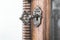 Vintage keyhole with key on vintage wooden cabinet with white space