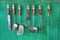 Vintage kitchen utensils on green painted wall, free copy space