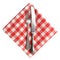 Vintage knife and fork on red plaid linen napkin isolated.