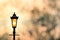 Vintage lamp post with sunset Background sillhouette