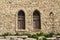 Vintage lancet windows on the background sandstone bricks