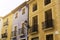 Vintage lantern and beautiful twisted wrought iron balconies on the facade of an old house of a European city