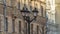 Vintage lantern with empty branches in the city on building background. Beautiful streetlight in front of old building.