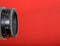 Vintage lens on red background